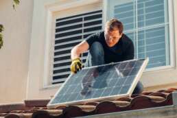 a man installing solar generator and power backup system